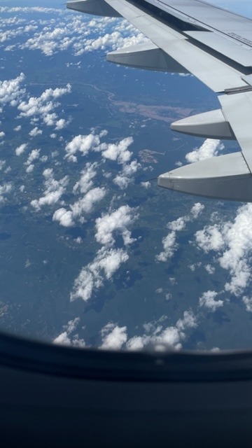 Photo taken out of an airplane above the clouds