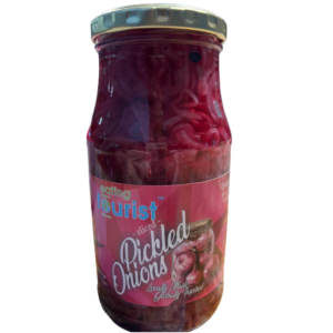Glass bottle filled with sliced red onions in a sweet vinegar brine and pickled for Eating Tourist®