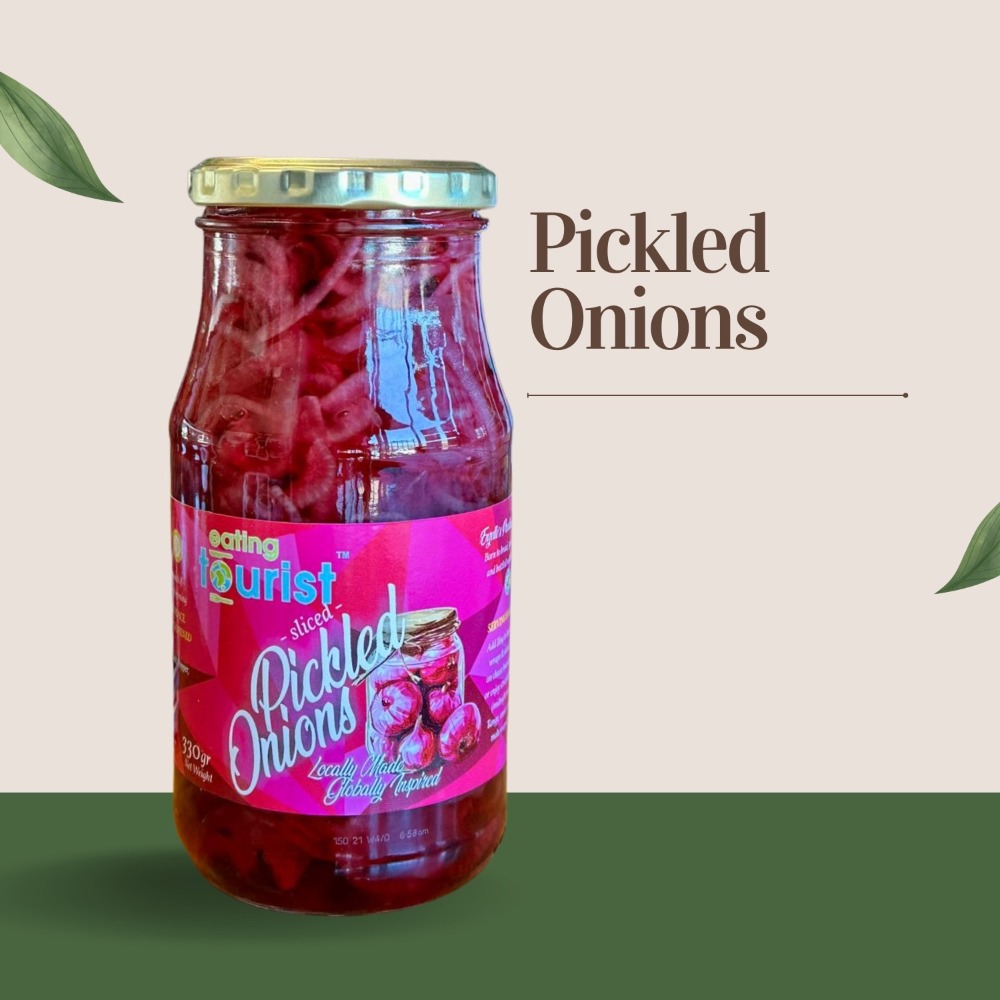Eating Tourist Pink sliced Pickle onions in glass jar.