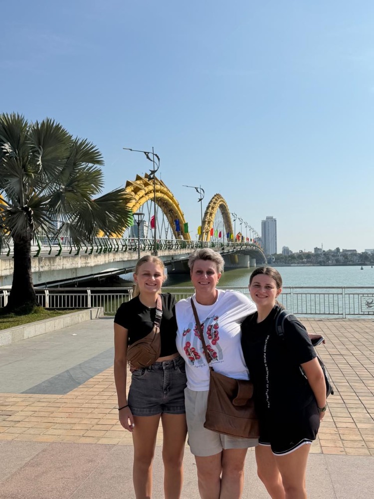 Photo of Enzelle, Leonelle and Lerika infront of the Dragon Bridge in Da Nang.